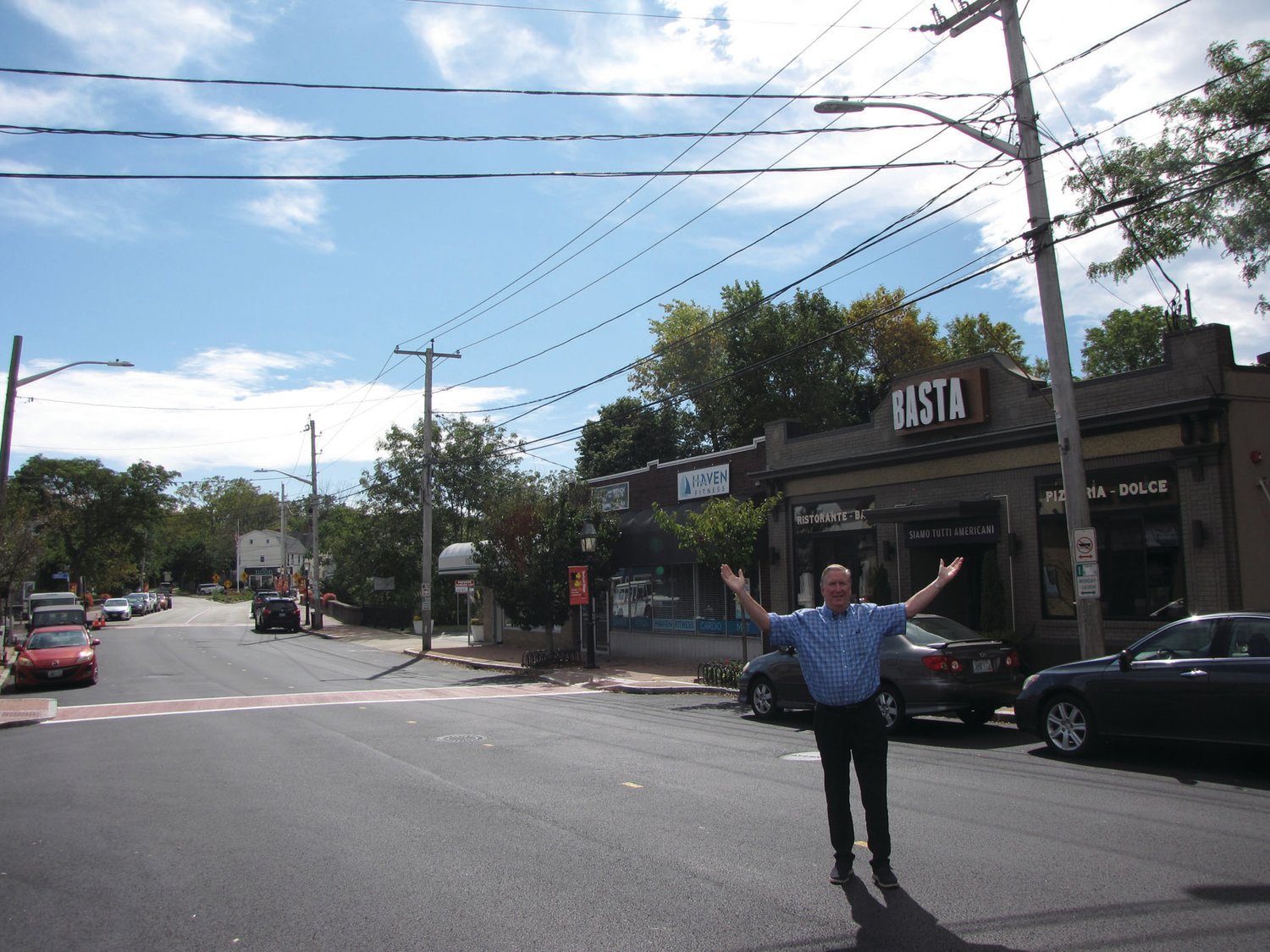 IN THE VILLAGE: Mayor Ken Hopkins pauses while crossing Broad Street during a recent interview with the Herald. Pawtuxet Village, which will host the Gaspee Days 250th anniversary celebration next year, has been the focus of the administration’s latest neighborhood revitalization project.